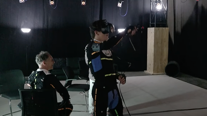 Steven Spielberg using a VR headset in a movie set.