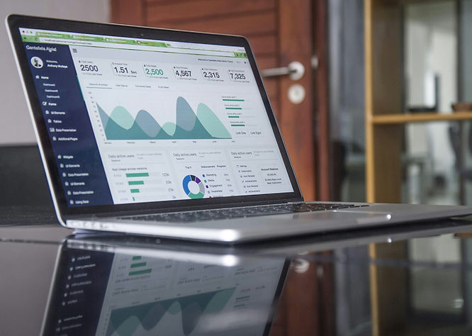 a laptop with business statistics graph on it